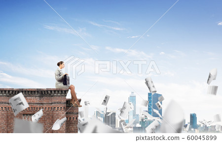 Businesswoman or accountant on brick roof against modern city scape Businesswoman or accountant on brick roof against modern city scape 60045899