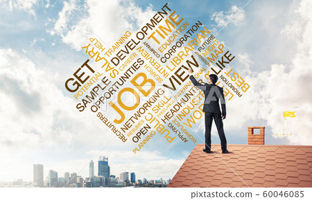 Young businessman standing on house roof and writing leadership Young businessman standing on house roof and writing leadership 60046085