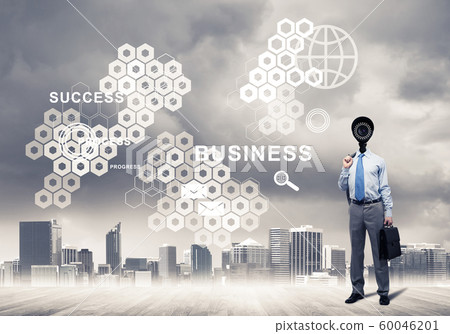 Camera headed man standing on wooden floor against modern cityscape 60046201