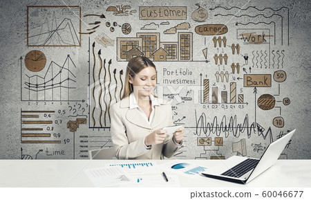 Elegant businesswoman sitting at table Elegant businesswoman sitting at table 60046677