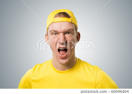 Frenzied teenager screaming with anger. 60046804