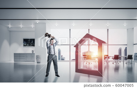 Stone home silhouette as symbol for real estate insurance crashed by man 60047005