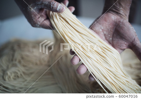 Making Handmade Noodles on wood background Making Handmade Noodles on wood background 60047016