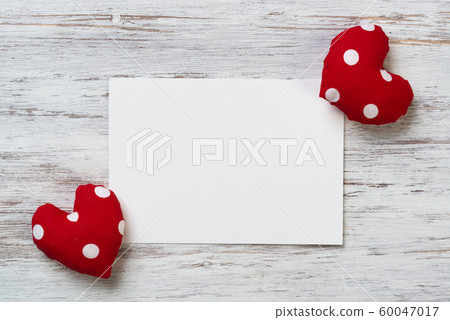 Blank sheet of paper and red dotted hearts Blank sheet of paper and red dotted hearts 60047017