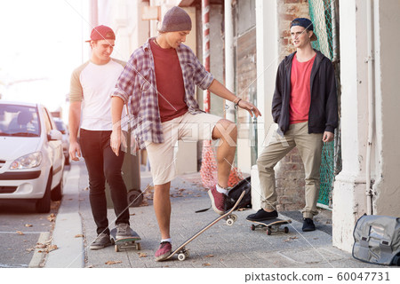 Guys skateboarders in street Guys skateboarders in street 60047731