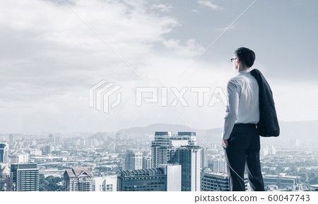 Concept of business success and control with confident boss against cityscape background 60047743