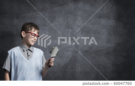 Curious school boy with magnifier Curious school boy with magnifier 60047760