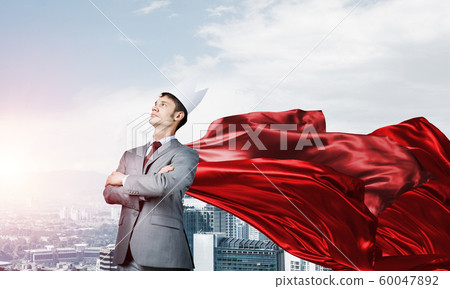 Concept of power and sucess with businessman superhero in big city Concept of power and sucess with businessman superhero in big city 60047892