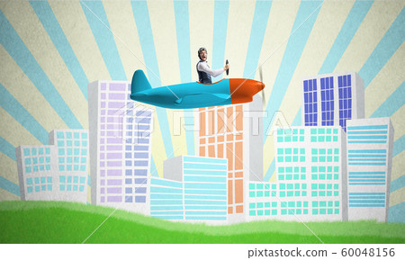 Man in aviator helmet sitting in propeller plane 60048156