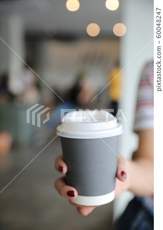 take home hot cappuccino or Latte art coffee made from milk with female hand take home hot cappuccino or Latte art coffee made from milk with female hand 60048247