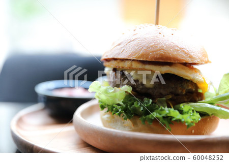 Beef hamburger with cheese green salad egg and sauce in restaurant Beef hamburger with cheese green salad egg and sauce in restaurant 60048252