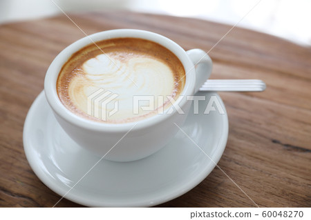 cappuccino or Latte art coffee made from milk on the wood table in coffee shop 60048270
