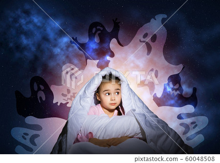 Scared girl with pillow hiding under blanket 60048508