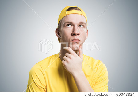 Redhead student looks pensively upwards Redhead student looks pensively upwards 60048824