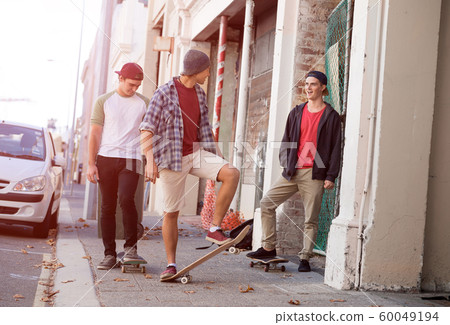 Guys skateboarders in street 60049194