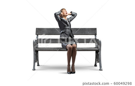 Stressful woman sitting on wooden bench Stressful woman sitting on wooden bench 60049298