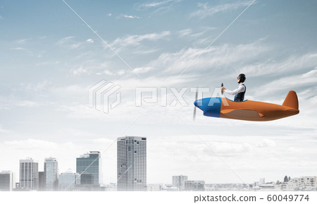 Pilot sitting in cabin of small airplane Pilot sitting in cabin of small airplane 60049774