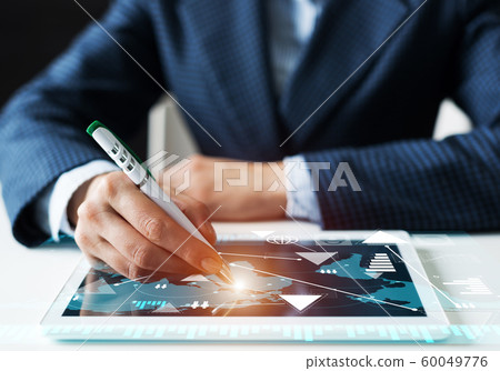 Man in business suit using tablet computer Man in business suit using tablet computer 60049776