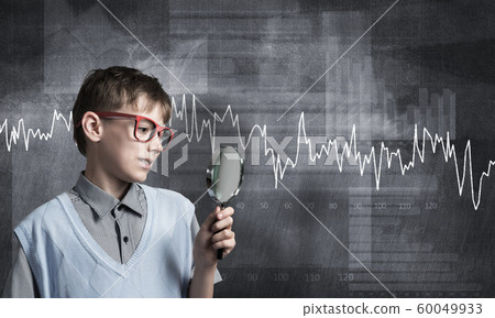 Curious school boy with magnifier 60049933