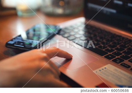 Woman hand working at coffee shop hand on keyboard with close up Woman hand working at coffee shop hand on keyboard with close up 60050686