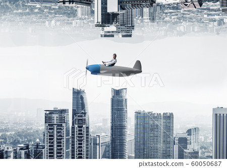 Young pilot sitting in cabin of small airplane Young pilot sitting in cabin of small airplane 60050687