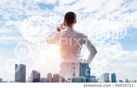 Concept of business success and control with confident boss against cityscape background 60050721