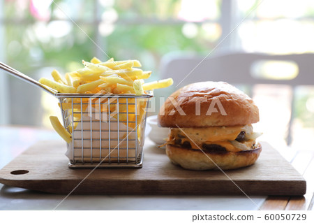 Beef Hamburger with fries and ketchup on wood bard , fast food Beef Hamburger with fries and ketchup on wood bard , fast food 60050729
