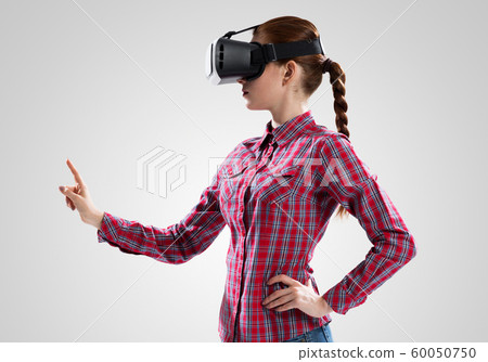 Girl in mask experiencing virtual reality as new entertainment device Girl in mask experiencing virtual reality as new entertainment device 60050750