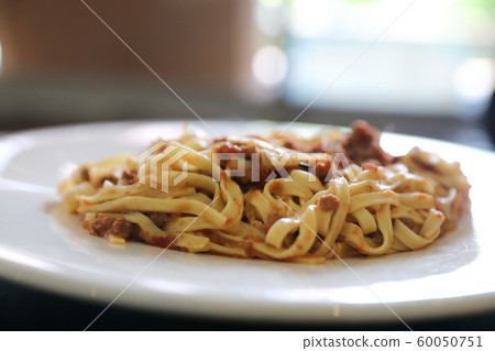 spaghetti Bolognese with minced beef and tomato sauce garnished with parmesan cheese and basil , Italian food spaghetti Bolognese with minced beef and tomato sauce garnished with parmesan cheese and basil , Italian food 60050751