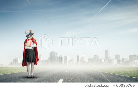 Girl power concept with cute kid guardian against cityscape background . Mixed media Girl power concept with cute kid guardian against cityscape background . Mixed media 60050769