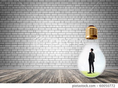 Businessman trapped in bulb Businessman trapped in bulb 60050772