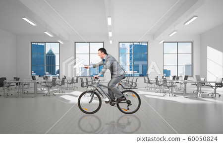 Businessman with paper documents in hand on bike Businessman with paper documents in hand on bike 60050824