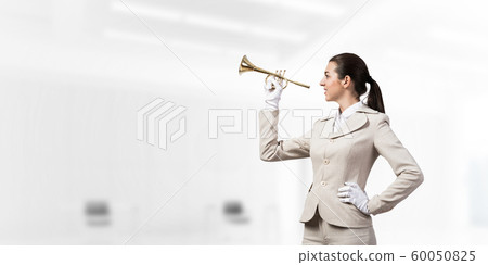 Woman playing trumpet brass instrument Woman playing trumpet brass instrument 60050825