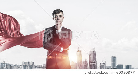 Concept of power and sucess with businessman superhero in big city 60050877
