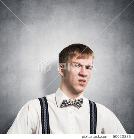 Distrustful redhead teenager looking at camera Distrustful redhead teenager looking at camera 60050886