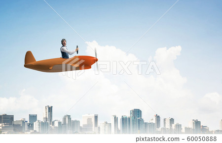 Scared pilot with open mouth in airplane Scared pilot with open mouth in airplane 60050888
