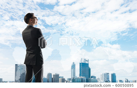 Concept of business success and control with confident boss against cityscape background Concept of business success and control with confident boss against cityscape background 60050895