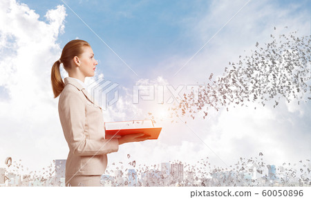 Woman looking at flying out random letters Woman looking at flying out random letters 60050896