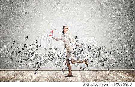 Woman running with vintage red phone Woman running with vintage red phone 60050899