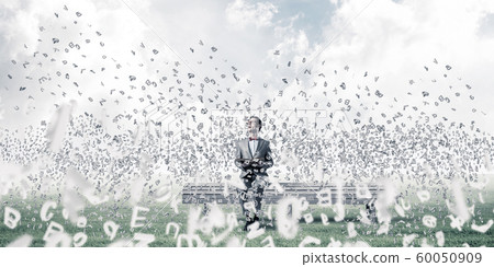 Young businessman or student studying the science and symbols fly around 60050909