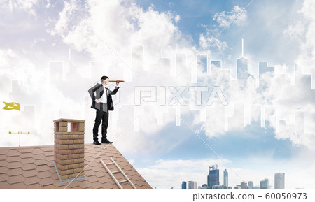 Engineer man standing on roof and looking in spyglass. Mixed media Engineer man standing on roof and looking in spyglass. Mixed media 60050973