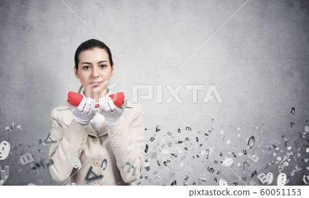 Attractive woman holding vintage red phone Attractive woman holding vintage red phone 60051153