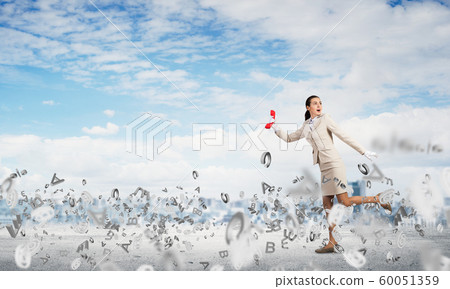 Woman runs away from something Woman runs away from something 60051359