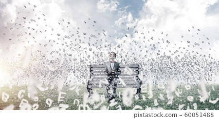 Young businessman or student studying the science and symbols fly around Young businessman or student studying the science and symbols fly around 60051488
