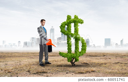 Entrepreneur watering green plant of dollar 60051741