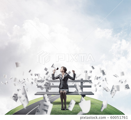 Business woman with megaphone on wooden bench Business woman with megaphone on wooden bench 60051761