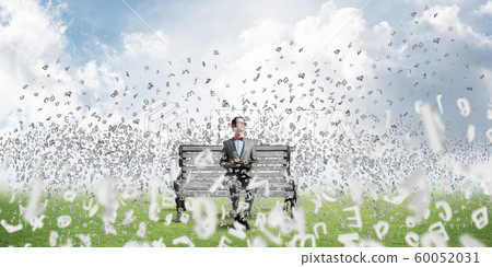 Young businessman or student studying the science and symbols fly around Young businessman or student studying the science and symbols fly around 60052031