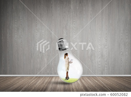 Businesswoman trapped in bulb Businesswoman trapped in bulb 60052082