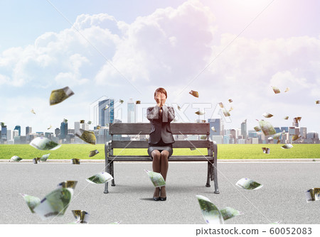 Young woman sitting on wooden bench outdoor Young woman sitting on wooden bench outdoor 60052083