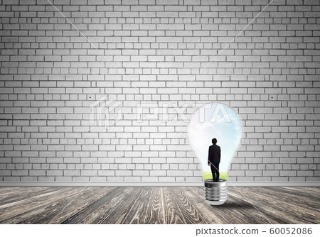 Businessman trapped in bulb 60052086
